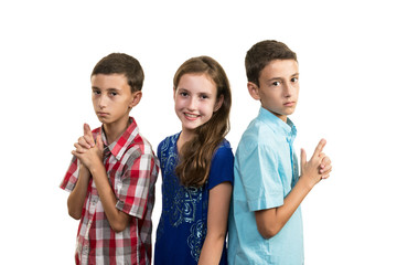 Tweenager triples, two brothers and one sister, brothers in protecting pose with sister in the...