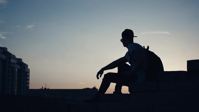 Silhouette of a man in the city at sunset