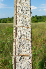 Old concrete pillar. The destruction of concrete over time.