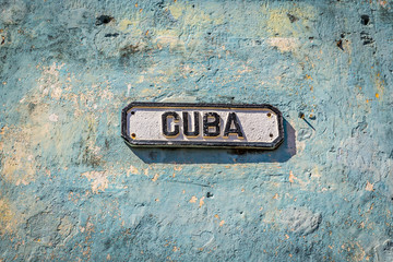 Traditional sign of Cuba in a old blue wall