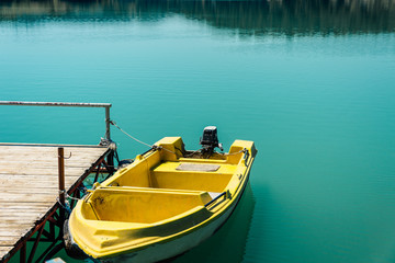 Obraz premium Moored yellow boat. Green Canyon, Manavgat. Rest in Side, Turkey. Pier on the Green Canyon.Travel in warm countries. Boat trip