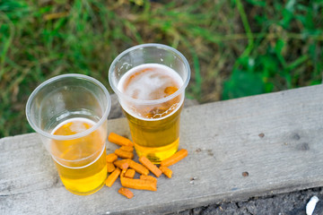 Beer in a plastic Cup. Alcohol at the picnic.