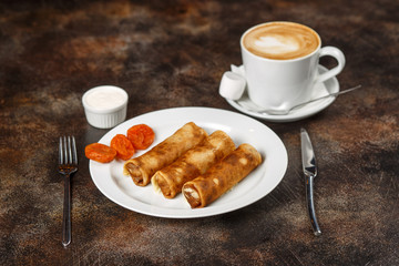Crepes stuffed with cottage cheese and dried apricots