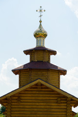 Fototapeta na wymiar Dome with a cross on the Church against the sky.