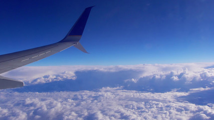 Naklejka na ściany i meble Airplane in the sky at plane sky clouds horizont