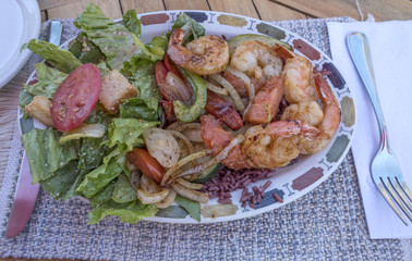 Grilled Shrimps Served with Green Salad in a Restaurant