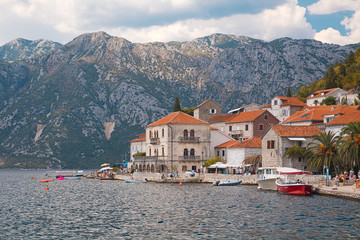 Epic European town near lake surrounded by mountains 