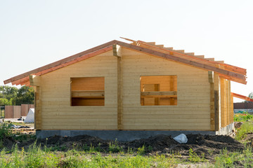 Fototapeta na wymiar Construction of a wooden house of laminated veneer lumber.