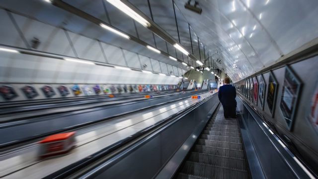 Unidentified people travel through underground train network in London, UK