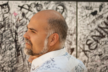 Man in front of graffiti