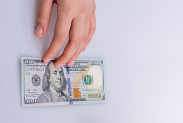 Hands holding American dollar banknotes and Turksh Lira banknotes side by side