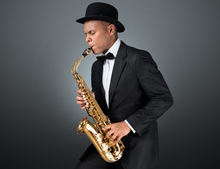 Close-up man playing on saxophone on white background