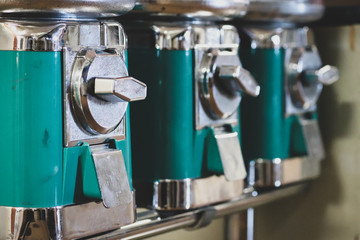 Green and iron old fashion knob turn candy dispenser