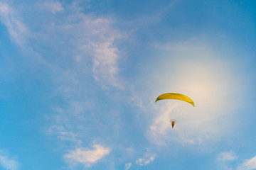 Man is riding para motor in beautiful  sunset cloud sky background.