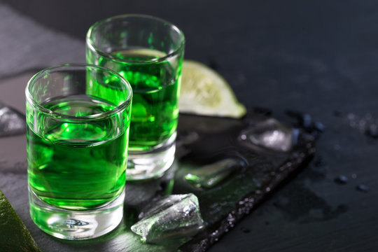Two glasses of absinthe with lime and ice