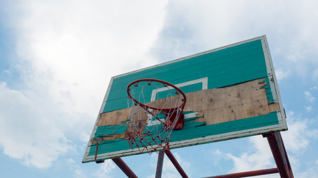 old Green basketball hoop  blue sky background
