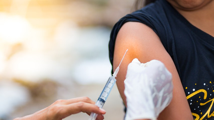 The doctor uses the syringe in the arm. , healthy and medical concept