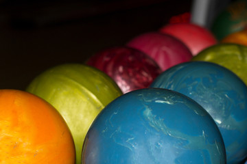 Fototapeta na wymiar Multicolored bowling balls of different weight ready for the game