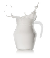 Splash in glass transparent jar filled with milk