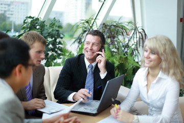 Group of four business people working at meeting