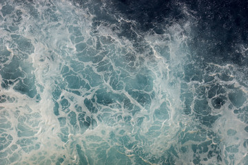 Foam on the deep sea waters seen from above