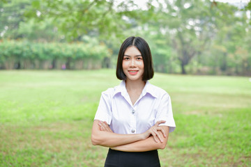 Education Concepts. Beautiful young Asian girl is thinking seriously. Beautiful Asian students are thinking in the garden. Beautiful young students are contemplating what they have learned.