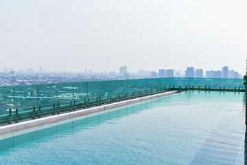 Swimming pool on roof top with beautiful city view at bangkok, thailand.