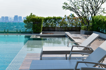 Swimming pool on roof top with beautiful city view at bangkok, thailand. - Powered by Adobe