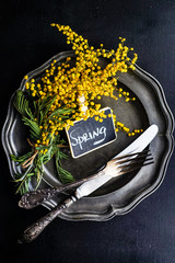 Spring table setting with mimosa flowers