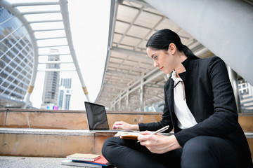 Business concept. Young businesswoman is working in business district. Young businesswoman happy to work.