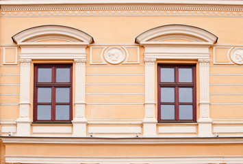 Two windows on a pink wall