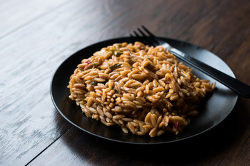 Turkish Style Cooked Orzo Pasta in Black Plate / Pilav or Pilaf.