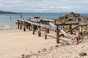 Abandoned wharf at a beach on the Waitutu Track on the south coast of New Zealand.