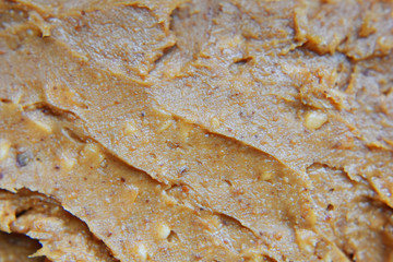 Crunchy peanut butter texture as abstract textured background.