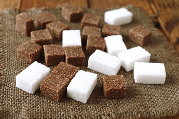 cataract of sugar cubes on wooden background