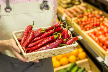 Red chili pepper in the hands of a woman.  