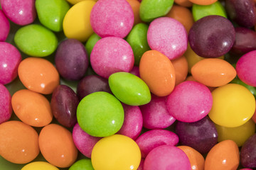Many colored candies in a background composition