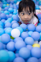 Fototapeta na wymiar Asian Chinese little girl playing at balls pool