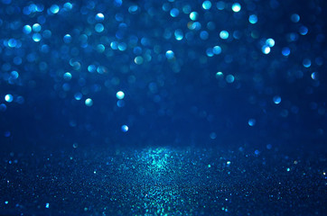 glitter vintage lights background. black, blue and silver. de-focused.