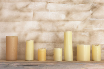 The candles are on the shelf.