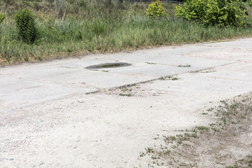 bad asphalt road, pit on the road