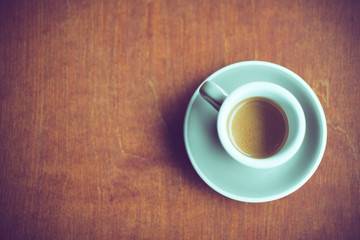 cup of espresso coffee on dark brown wood background with copy space on left
