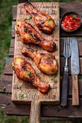 Tasty grilled chicken leg served with fresh sauce