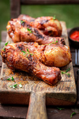 Spicy grilled chicken leg in summer garden