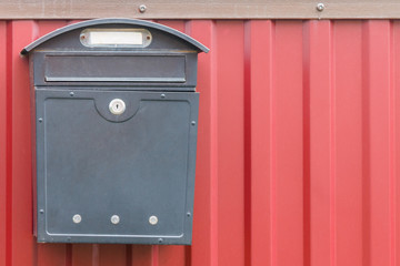 A beautiful mailbox hangs waiting for newspapers, parcels and letters.