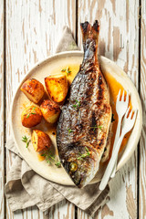 Fresh potatoes and seabream with cherry tomatoes and thyme