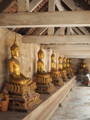 The glittering golden Buddha statues around the monastery. The worship of the Buddhist.