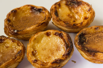 Pasteis de nata or pasteis de Belem is a traditional portuguese dessert from Lisbon. Isolated on a white background