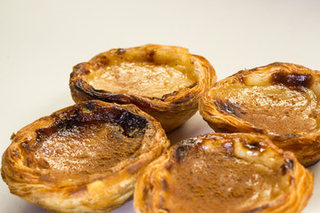 Pasteis de nata or pasteis de Belem is a traditional portuguese dessert from Lisbon. Isolated on a white background