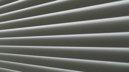 Obraz premium White jalousie background. Closeup, selective focus, black and white photo